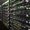 Vast mining farm facility with rows of running mining equipment